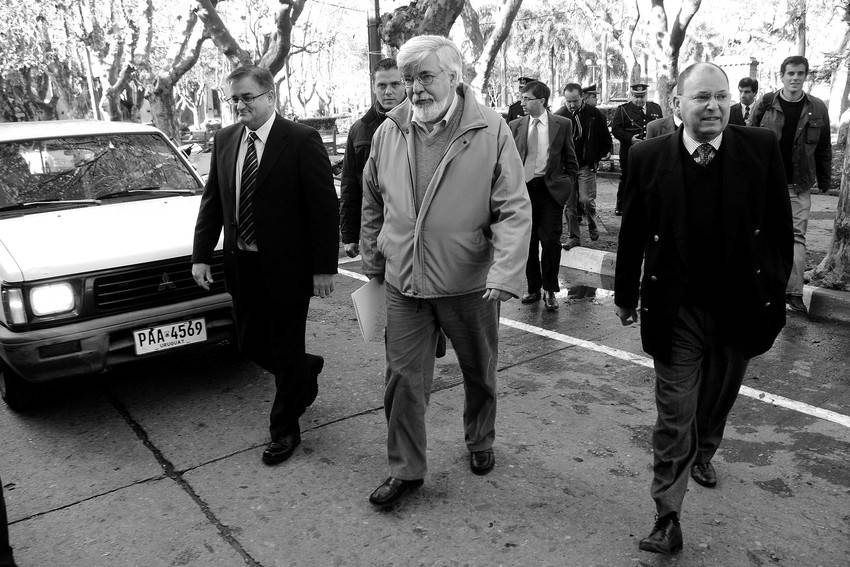 Los jefes de Policía de Lavalleja y Treinta y Tres, Leonardo Ruiz y Tabaré Gordiola, flanquean al ministro del Interior, Eduardo Bonomi, camino al Club Minas en la capital de Lavalleja, el sábado.