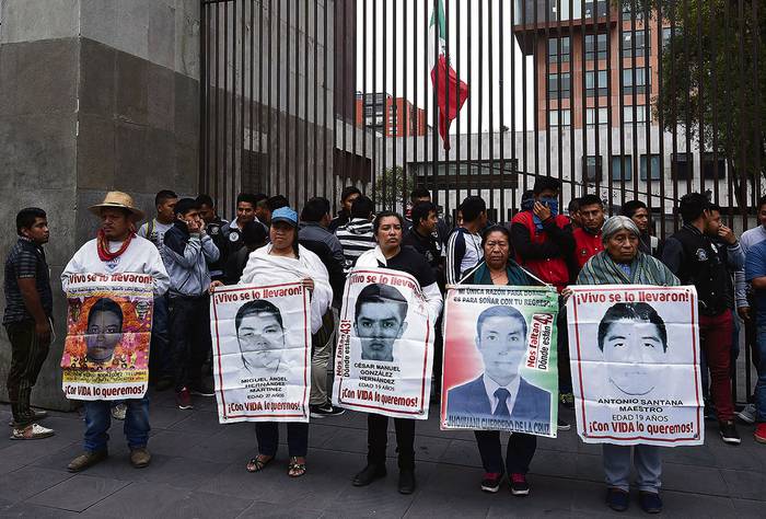 Familiares y compañeros de los 43 alumnos de la escuela de formación docente de Ayotzinapa, desaparecidos en 2014, durante una manifestación, el martes, frente a la Cancillería mexicana, en Ciudad de México.
 · Foto: Alfredo Estrella