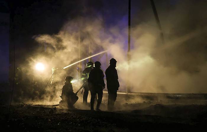 Bomberos ucranianos extinguen un incendio después de que un cohete provocara el corte del suministro de energía y agua en muchos distritos de Kharkiv (11.09.2022). · Foto: Sergey Kozlov, EFE