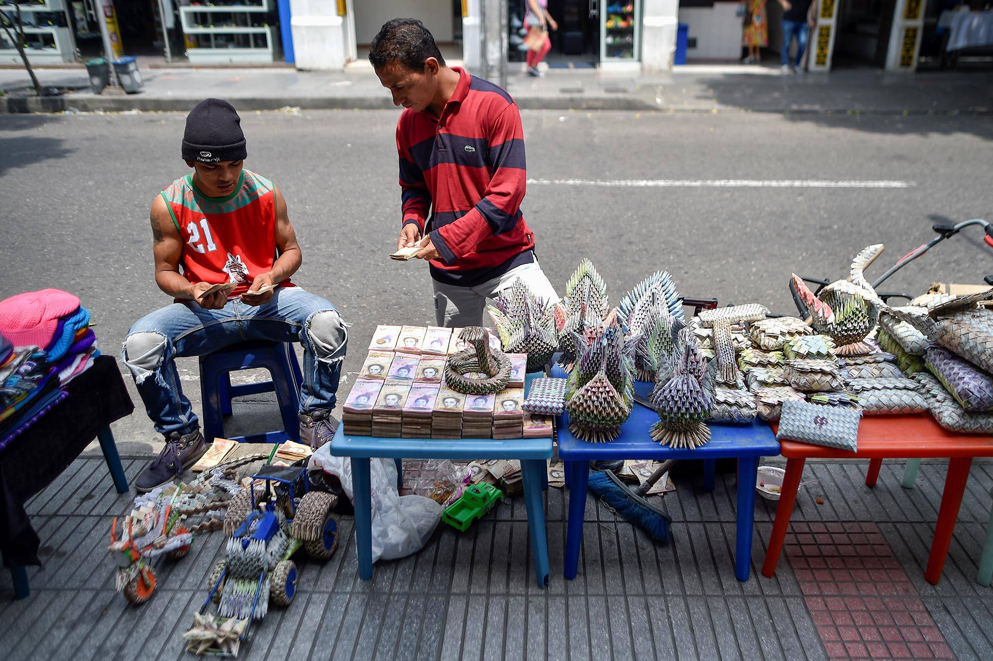 Venta de artesanías hechas con billetes de Bolívar en una calle de Cúcuta, Colombia, en la frontera con Venezuela, el 20 de febrero. El peso colombiano desplazó al devaluado bolívar venezolano en ciudades fronterizas. Foto: Luis Robayo, AFP.