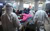 Personal médico con ropa aislante para protegerse contra un coronavirus atiende a un paciente en el hospital de la Cruz Roja de Wuhan. Personal médico con ropa aislante para protegerse contra un coronavirus atiende a un paciente en el hospital de la Cruz Roja de Wuhan.