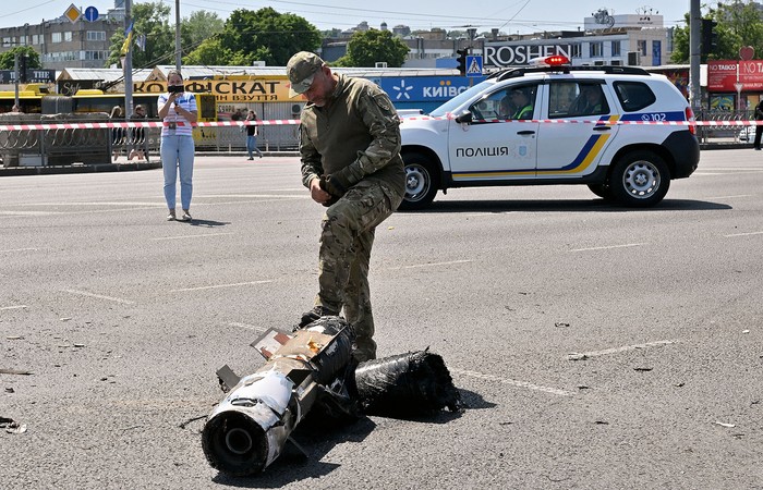 Un experto policial examina fragmentos de un misil ruso, en Kiev (29.05.2023). · Foto: Sergei Supinsky, AFP
