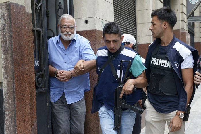 Miguel Sofía es retirado del juzgado por efectivos de Interpol, luego de declarar ante la jueza Fanny Canessa. · Foto: Andrés Cuenca