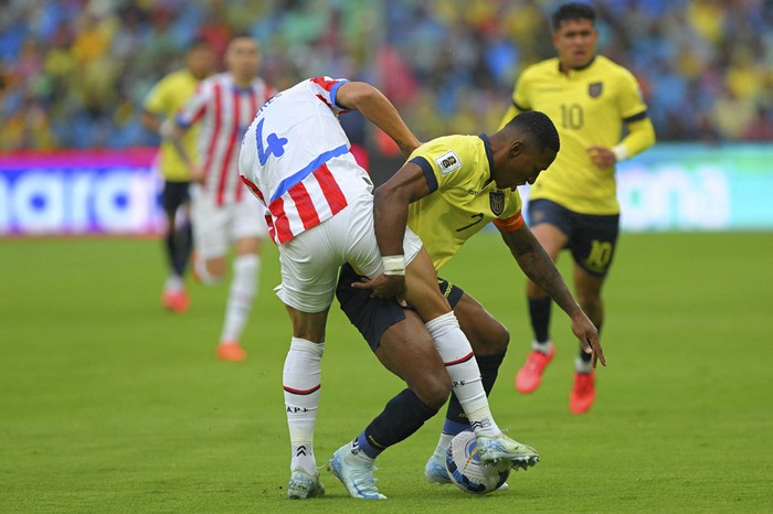 Juan Cáceres, de Paraguay, y Pervis Estupiñán, de Ecuador, en el estadio Rodrigo Paz Delgado, en Quito. · Foto: Rodrigo Buendía, AFP