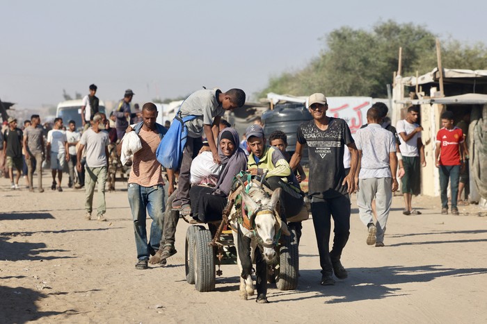Palestinos se dirigen a la zona de Mawasi, en Rafah, el 24 de julio, tras recibir ayuda humanitaria de un punto de distribución en el sur de la Franja de Gaza. · Foto: AFP