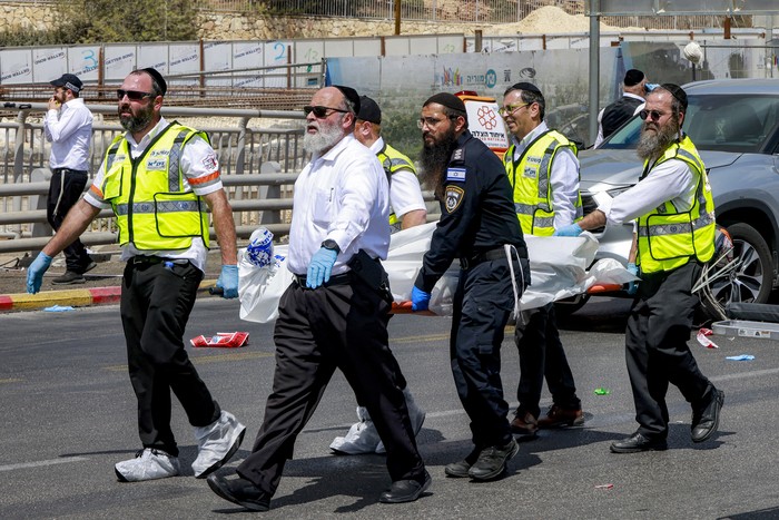 Miembros de los servicios de emergencia israelíes, ZAKA, transportan un cuerpo del lugar del tiroteo, el 8 de setiembre, en la carretera Ramot, en Jerusalén Oriental. Foto: Menahem Kahana, AFP. Miembros de los servicios de emergencia israelíes, ZAKA, transportan un cuerpo del lugar del tiroteo, el 8 de setiembre, en la carretera Ramot, en Jerusalén Oriental. Foto: Menahem Kahana, AFP.