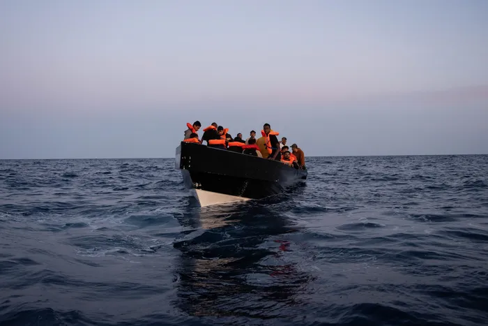 Migrantes que partieron de Libia rescatados por la ONG Open Arms, el 3 de junio, en el mar Mediterráneo. · Foto: Joan Gálvez, Anadoulu, AFP