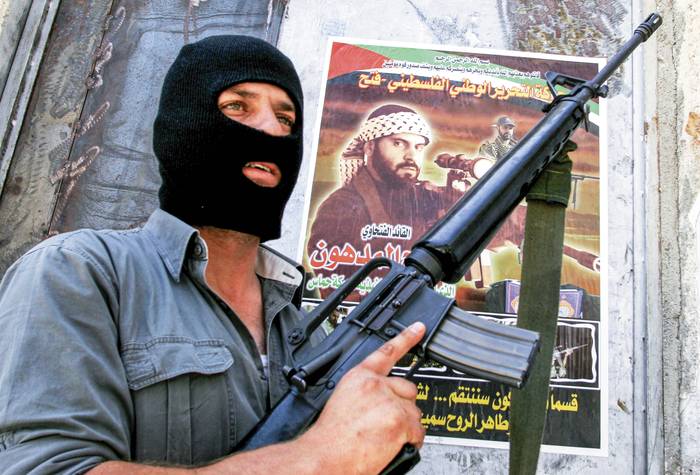 Militante del movimiento Al Fatah frente a un cartel que anuncia la muerte de un militante de ese grupo en la ciudad palestina de Nablus (archivo, junio de 2007). · Foto: Quique Kierszenbaum