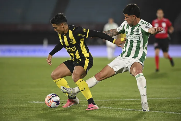 Matías Arezo, de Peñarol, y Felipe Álvarez, de Racing, el 4 de octubre, en el estadio Centenario. · Foto: Sandro Pereyra, Agencia Gamba