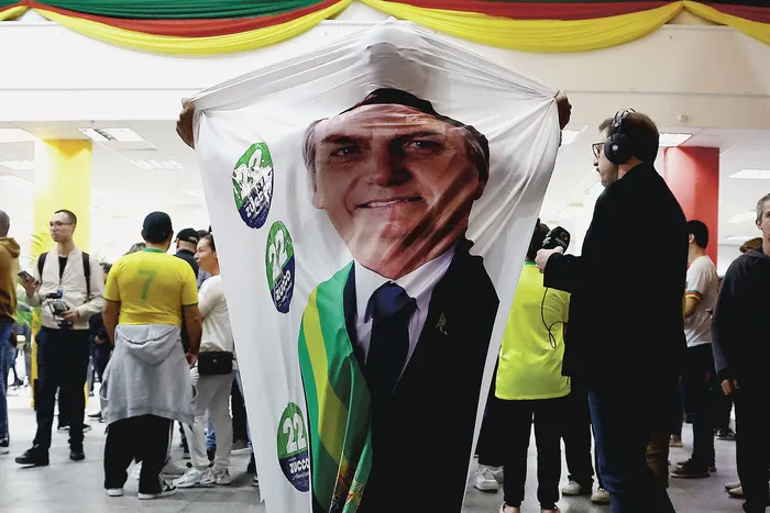 Periodistas y electores esperan la la difusión de los primeros resultados de las elecciones presidenciales en Porto Alegre, Brasil, el 4 de octubre. · Foto: Silvio Avila/ AFP