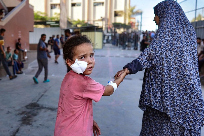 Una niña palestina herida es acompañada en el hospital Nasser luego del bombardeo israelí, el 14 de agosto, en Jan Yunis, en el sur de la Franja de Gaza. · Foto: Bashar Taleb, AFP