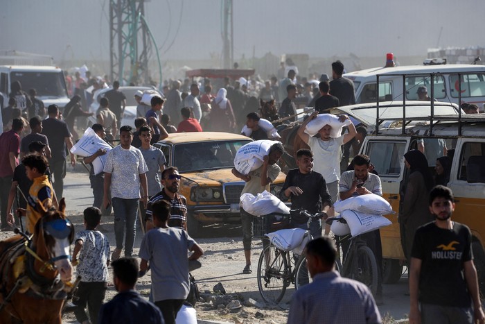 Palestinos desplazados transportan bolsas de ayuda alimentaria tras asaltar un almacén del Programa Mundial de Alimentos, el 28 de mayo, en Deir el-Balah, en el centro de la Franja de Gaza. · Foto: Eyad Baba, AFP Palestinos desplazados transportan bolsas de ayuda alimentaria tras asaltar un almacén del Programa Mundial de Alimentos, el 28 de mayo, en Deir el-Balah, en el centro de la Franja de Gaza. · Foto: Eyad Baba, AFP