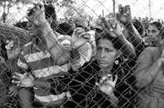 Familiares de los presos de la Granja Penal de Comayagua esperando noticias fuera de la cárcel, ayer, en Comayagua, Honduras.