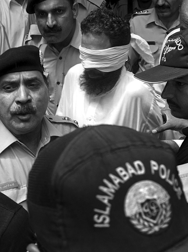Agentes de la Policía paquistaní escoltan al imán Jalid Yadun, acusado de falsear
pruebas contra una niña cristiana paquistaní encarcelada por blasfema tras quemar
presuntamente hojas del Corán, a su salida de una audiencia en el tribunal de Islamabad,
el domingo.  · Foto: Efe, Stringer