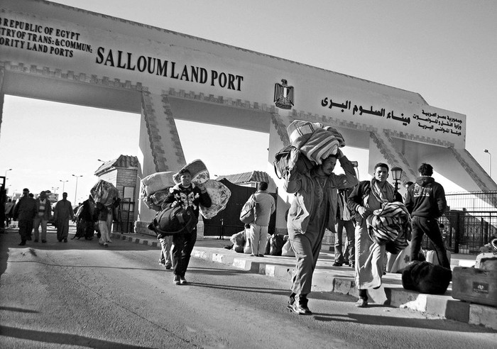 Ciudadanos egipcios abandonan Libia por el paso fronterizo de Al Salum, que está abierto las 24 horas para permitir el regreso de los
egipcios a su país y el paso de quienes quieran abandonar Libia.  · Foto: EFE, s/d de autor