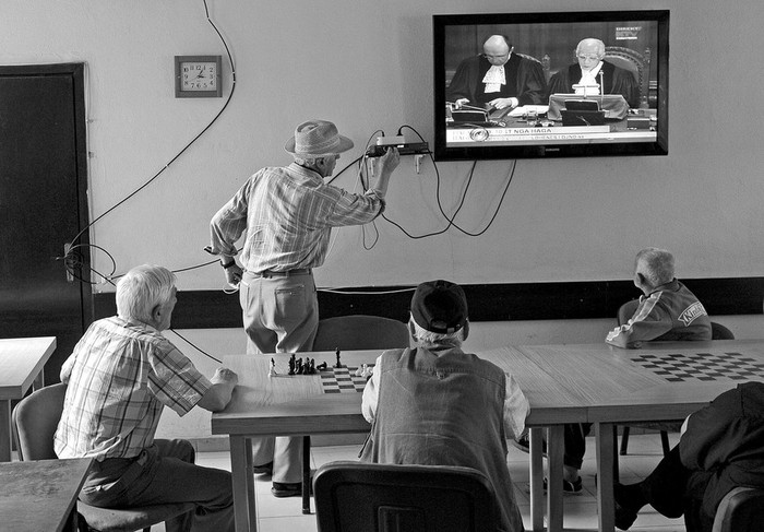 Albano-kosovares siguen por televisión la lectura sobre la legalidad de la declaración unilateral de independencia de Kosovo, en Pristina.
 · Foto: Efe, Kushtrim Ternava