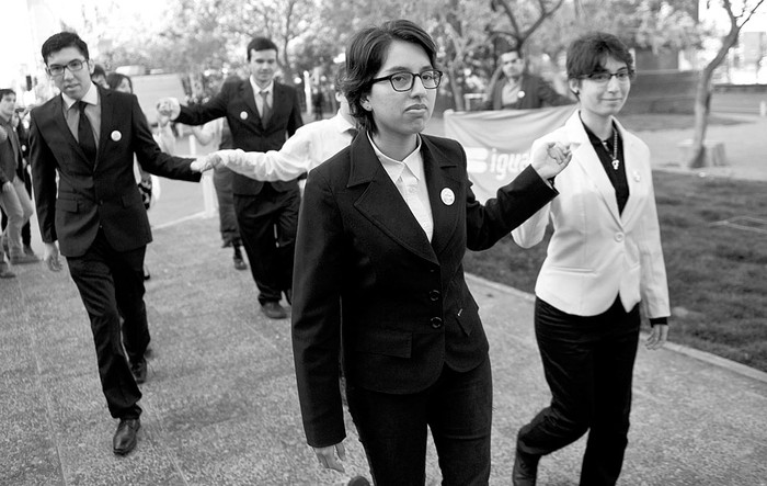 Activistas de los derechos gays bailan fuera de la Oficina de Registro Civil, después de la ceremonia de matrimonio de Roxana Ortiz y Virginia Gómez, ayer, en Santiago de Chile. Foto: Martín Bernetti, Afp