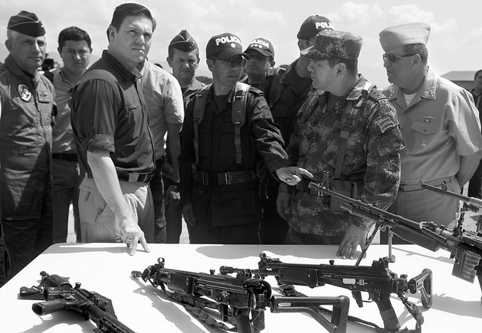 El ministro de Defensa de Colombia, Juan Carlos Pinzón, y parte de la cúpula militar observan el armamento perteneciente a las FARC capturado en la operación en la que murieron los jefes de las FARC Manuel Ángel Cardona Paz, alias El Burro, y Arley Medina Prado, alias Jaimito, del sexto frente de las FARC. · Foto: Christian Escobar Mora, Efe