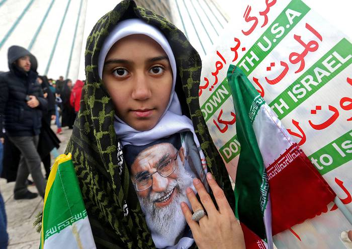 Una niña iraní con una imagen del líder supremo, Ali Khamenei, durante la ceremonia que celebra el 40º aniversario de la revolución islámica, ayer, en la torre Azadi, en Teherán. 
 · Foto: Atta Kenare, AFP
