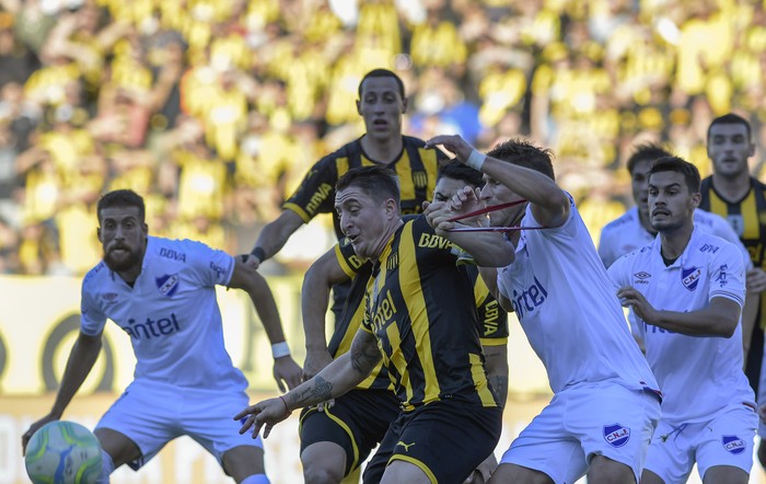 Cristian Rodríguez, de Peñarol, y Gonzalo Bergessio, de Nacional, en el estadio Campeón del Siglo.  · Foto: Sandro Pereyra