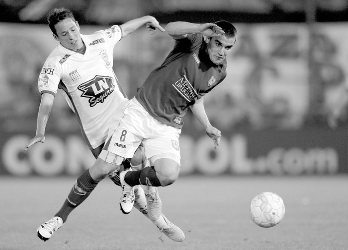 Mauro Bogado (Huracán) y Mauro Arambarri (Defensor Sporting) en el estadio Tomás Ducó, en Buenos Aires, Argentina, el 20 de octubre de 2015. Foto: Juan Mabromata,Afp