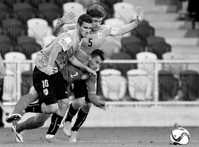 Gastón Pereiro y Nahitan Nández, de Uruguay, y Milan Gajic, de Serbia, ayer, en el Mundial sub 20 de Nueva Zeanda. Foto: Dianne Manson, Efe