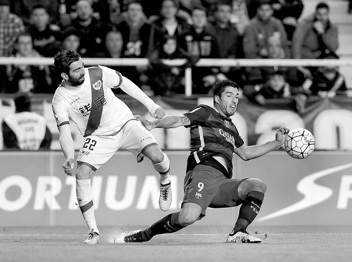 Luis Suárez, de Barcelona, y Diego Llorente, de Rayo Vallecano, ayer, en el estadio de Vallecas, en Madrid. Foto: Pierre-Philippe Marcou, Afp