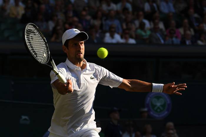 El serbio Novak Djokovic contra el estadounidense Denis Kudla, en Wimbledon 2019, Londres.

 · Foto: Ben Stansall, AFP