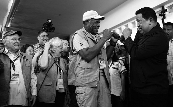 El actor estadounidense Danny Glover y el presidente Hugo Chávez; atrás, la senadora Lucía Topolansky, en un centro electoral en Caracas. / foto: miraflores, s/d de autor, efe · Foto: Miraflores, s/d de autor, Efe