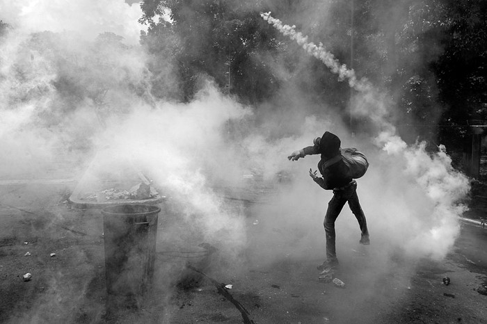 Un estudiante de la Universidad Central de Venezuela se enfrenta a la policía antidisturbios, durante una protesta contra el gobierno venezolano, ayer, en Caracas, Venezuela. Foto: Federico Parra, AFP