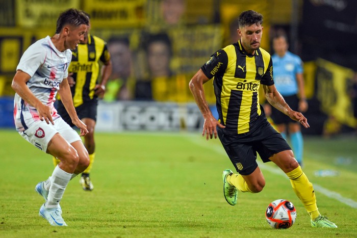 Nicolas Tripichio, de San Lorenzo, y Rodrigo Pérez, de Peñarol, este jueves, en el Campeón del Siglo. · Foto: Gianni Schiaffarino