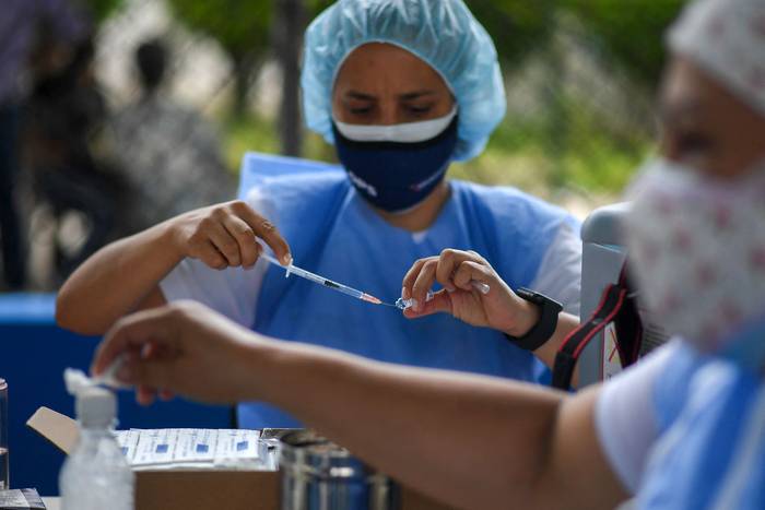 Un trabajador de salud prepara una dosis de la vacuna Sputnik V, durante una jornada de vacunación en el barrio 23 de Enero de Caracas, el 7 de junio de 2021.
 · Foto: Federico Parra, AFP