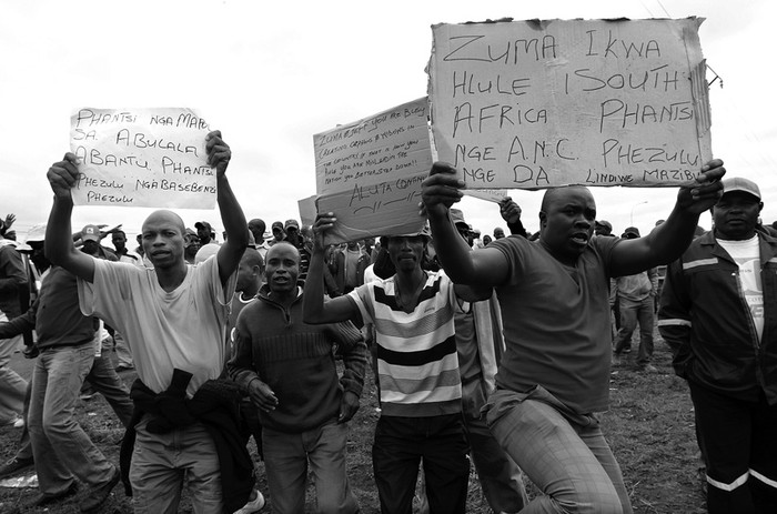 Mineros de la mina Anglo Platinum durante una marcha pacífica interrumpida por la policía que bloqueó una carretera para evitar que los manifestantes llegaran ayer a la comisaría en Rustenburg.  · Foto: Efe, Kim Ludbrook