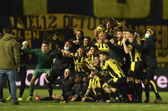 Los jugadores de Peñarol festejan la clasifición a cuartos de final de la Sudamericana, anoche, en el estadio Campeón del Siglo. · Foto: Pablo Porciúncula, AFP.