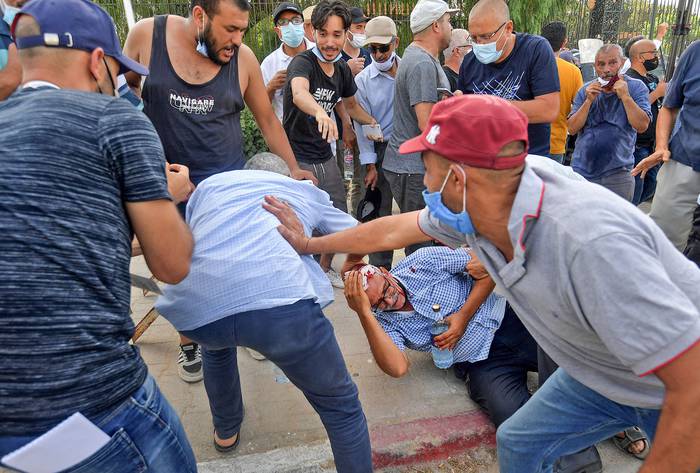 Un partidario del partido islamista Ennahda resulta herido por una piedra durante una protesta frente al edificio del parlamento, ayer, en la capital, Túnez. · Foto: Fethi Belaid, AFP
