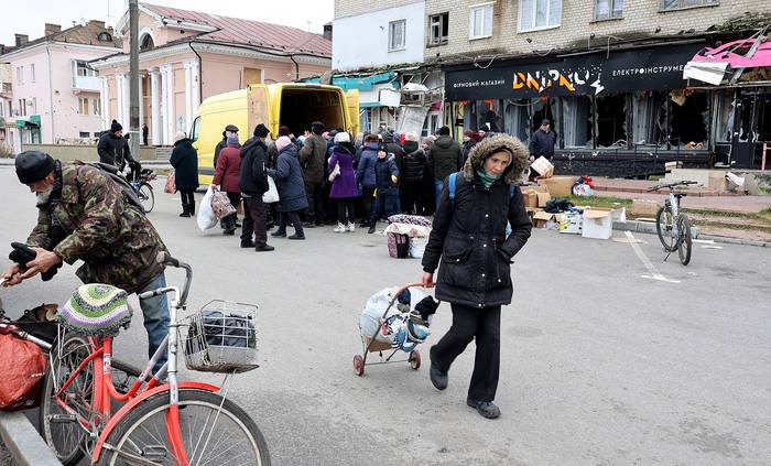 Voluntarios distribuyen ayuda humanitaria, en la ciudad de Izium en la región de Járkov en Ucrania (28.11.2022). · Foto: Sergey Kozlov, EFE